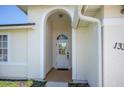 Elegant arched entryway leading to the front door of this inviting home at 13346 Carter Ave, Port Charlotte, FL 33981