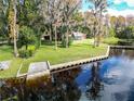 Lakefront home with a well-maintained lawn and shoreline protection at 18120 Wayne Rd, Odessa, FL 33556