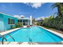 The sparkling pool invites you for a swim, with the house and lush greenery creating a private oasis at 2993 W Vina Del Mar Blvd, St Pete Beach, FL 33706
