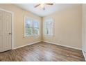 Simple bedroom with wood floors and ceiling fan at 4411 3Rd S Ave, St Petersburg, FL 33711
