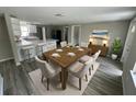 Dining area with table, chairs, and view of the kitchen with white countertops at 5038 Galaxy Dr, New Port Richey, FL 34652