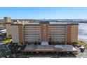 Exterior view of a multi-story building with balconies overlooking the water at 5130 Brittany S Dr # 505, St Petersburg, FL 33715