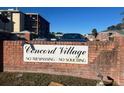 Concord Village community entrance sign with brick wall and landscaping at 1020 85Th N Ave # 224, St Petersburg, FL 33702