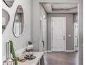 Welcoming foyer with decorative mirrors, a console table, and modern decor at 16018 10Th E Ave, Bradenton, FL 34212