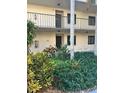 View of the front exterior of a condo building with lush landscaping at 2209 Belleair Rd # C18, Clearwater, FL 33764