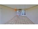 Tiled covered entryway with a stone accent wall and front door at 2701 Lancaster Dr, Sun City Center, FL 33573