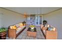 Covered patio with wicker furniture and tiled floor at 2701 Lancaster Dr, Sun City Center, FL 33573
