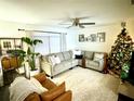 Bright living room featuring a cozy sectional sofa and a Christmas tree at 3801 N Ridge Ave, Tampa, FL 33603