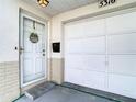 Welcoming front door and attached one-car garage of this inviting home at 5316 Buttonwood Dr, New Port Richey, FL 34652