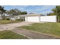 Single-story home with a white picket fence and attached garage at 6459 30Th N Ave, St Petersburg, FL 33710