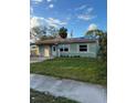 Green house with a two-car garage and carport at 1787 Shore Acres Ne Blvd, St Petersburg, FL 33703