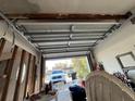 Garage with damaged door and exposed support beams at 1787 Shore Acres Ne Blvd, St Petersburg, FL 33703