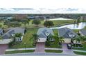 Three similar houses in a community near a golf course and pond at 1847 Pacific Dunes Dr, Sun City Center, FL 33573