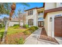 House exterior showcasing a walkway to the double-door entry at 18801 Chaville Rd, Lutz, FL 33558