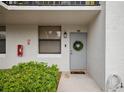 Condo entrance with gray door and wreath at 1945 Pelican Landing Blvd # 616, Clearwater, FL 33762