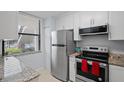 Kitchen with stainless steel appliances and granite counters at 1945 Pelican Landing Blvd # 616, Clearwater, FL 33762