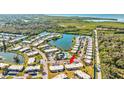 Aerial view showing condo location in community with pool and lake at 4235 Stratford Dr, New Port Richey, FL 34652