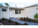 Newly renovated home with a landscaped walkway and front door at 5713 86Th N Ave, Pinellas Park, FL 33782