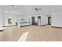 Spacious kitchen with modern two-tone cabinets, stainless steel appliances and light wood floors at 6303 Barton Rd, Plant City, FL 33565