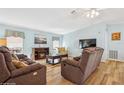 Relaxing living room featuring reclining sofas and a fireplace at 64 Pelican S Dr, Oldsmar, FL 34677