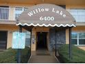 Entrance to the Willow Lake building with an awning, stone facade, and tow-away zone sign at 6400 46Th N Ave # 105, Kenneth City, FL 33709