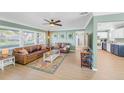 Inviting living room featuring a brown leather couch, decorative rug, and large windows at 6426 29Th N Ave, St Petersburg, FL 33710