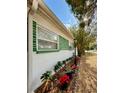 Side view showcasing the home's unique green accents and landscaping at 6951 19Th N Way, St Petersburg, FL 33702