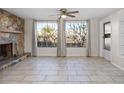 Gathering room with tile floors, a stone fireplace, and large windows at 9167 108Th St, Seminole, FL 33772