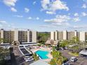 Inviting community pool surrounded by lush greenery and condo buildings at 2700 Cove Cay Dr # 2F, Clearwater, FL 33760