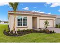 Exterior of a lovely single-story home with a tile roof and manicured landscaping, including palm trees at 11726 Renaissance Blvd, Venice, FL 34293