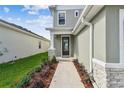 Inviting front entry with manicured landscaping and stone accents at 11846 Mile Marsh Dr, Riverview, FL 33569