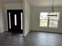 Bright entryway featuring a black front door with ornate glass panels and a view of the outside at 12186 Lamont Dr, Spring Hill, FL 34608