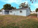 Ranch style home with blue exterior, large windows, and a spacious yard at 1817 Oregon Ne Ave, St Petersburg, FL 33703