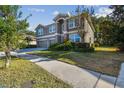 Two-story house with three-car garage and manicured lawn at 2212 Valterra Vista Way, Valrico, FL 33594