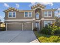 Two story house with three car garage and neat landscaping at 2212 Valterra Vista Way, Valrico, FL 33594