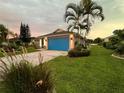 Home exterior with a vibrant blue garage door at 2765 Mauritania Rd, Punta Gorda, FL 33983