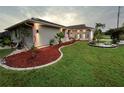 Landscaped yard with curb appeal and modern lighting at 2765 Mauritania Rd, Punta Gorda, FL 33983