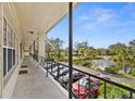 Condo hallway with view of pond and parking lot at 4143 56Th N St # 1003, Kenneth City, FL 33709