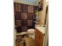 Bathroom with animal print decor, wooden vanity, and shower/tub combo at 4150 15Th S Ave, St Petersburg, FL 33711