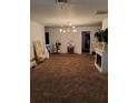 Spacious living room with plush carpeting, unique light fixture, and a fireplace at 4150 15Th S Ave, St Petersburg, FL 33711