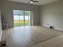 Living room with sliding glass doors leading to backyard and wood-look flooring at 5239 Braddock Dr, Zephyrhills, FL 33541