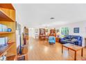 Spacious living room with hardwood floors, ample natural light, and a view of the dining area at 6110 2Nd S Ave, St Petersburg, FL 33707