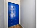 Bright blue front door with a keypad lock and a welcome mat at 6462 92Nd N Pl # 802, Pinellas Park, FL 33782