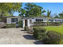 Inviting single-story home with a neatly landscaped front yard and a freshly sealed driveway at 7235 12Th N Ave, St Petersburg, FL 33710