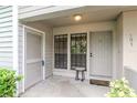 Inviting condo front entrance with 'Welcome to our home' doormat, neutral paint and simple decor at 8737 Bardmoor Pl # 101, Seminole, FL 33777