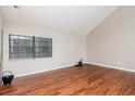 Bright living room with vaulted ceiling, wood flooring, and a large window at 8737 Bardmoor Pl # 101, Seminole, FL 33777