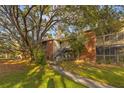 Inviting two-story condo building featuring brick accents, outdoor stairs, and verdant landscaping at 9100 Dr Martin Luther King Jr N St # 1706, St Petersburg, FL 33702