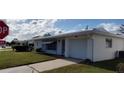 Inviting single-story home featuring a attached garage and well-maintained front yard at 9350 Mainlands W Blvd, Pinellas Park, FL 33782