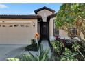 Front entry with landscaping and dark door at 204 Mystic Falls Dr, Apollo Beach, FL 33572