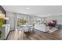 Combined living and dining area with modern furniture and large windows at 5009 Rocky Coast Pl, Palmetto, FL 34221